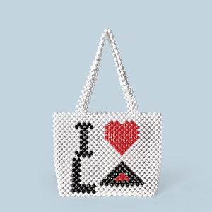 Detail of handcrafted beaded tote bag featuring the I Love LA heart pattern in red and black