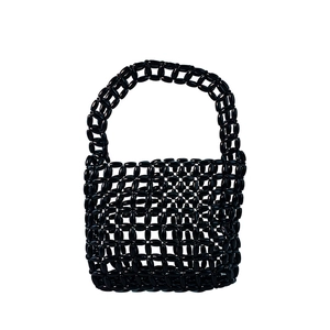 Detail view of handmade black beaded handbag featuring hollow mesh weave and glossy finish