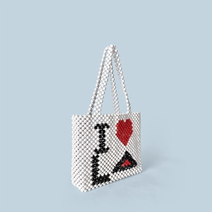 Detail of handmade beaded tote bag featuring the iconic I Love LA heart pattern