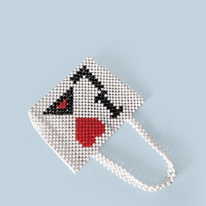 Detail of handmade beaded tote bag with a poker Ace of Hearts pattern and beaded handles