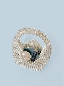 Handmade pearl beaded Boston handbag with phone and cosmetics showing storage capacity