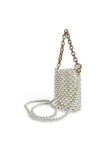 Detail of handmade pearl mini bag with gold chain and woven structure on white background