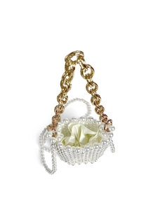 Detail of pearl woven bucket bag with gold chain and cream satin drawstring liner