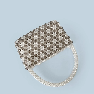 Detailansicht der handgefertigten Perlen-Handtasche mit geometrischem Muster und Griff