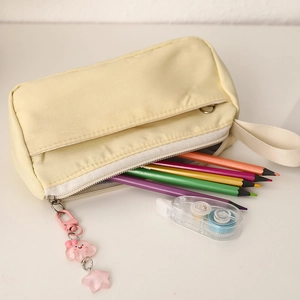 Light yellow canvas pencil case featuring a wide handle and cute cloud charm detail