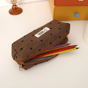 Detail of a large capacity brown corduroy polka dot pencil case showing internal storage