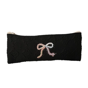Large capacity black textured pencil case with a colorful woven bow and zip closure