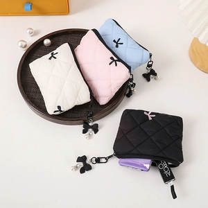 Quilted bow makeup bags in white, pink, blue, and black with pearl charms set
