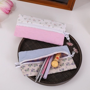 Quilted floral pencil pouch detail with heart zipper and woven label for stationery