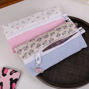 Set of four floral and quilted fabric pencil cases with heart pendant and zipper