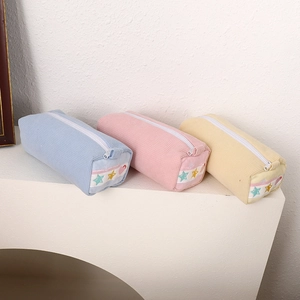 Three macaron-colored waffle fabric strawberry pencil cases in light blue, pink, and yellow
