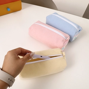 Large capacity waffle texture strawberry pencil case in pastel blue, pink and beige tones