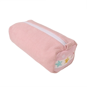 Pink knitted pencil case with colorful star embroidery and white zipper on white background