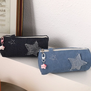 Denim star pencil cases in dark and light blue with cute star pendants on white display