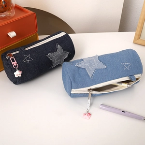 Detail of denim pencil case with star patches, metal zipper, and cute star charm