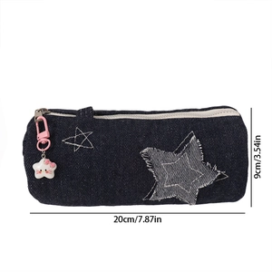 Close-up of denim pencil case featuring star embroidery and a cute cat zipper charm