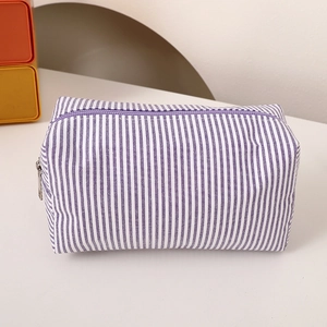 Detail of purple and white striped pencil case showing textured fabric and zipper