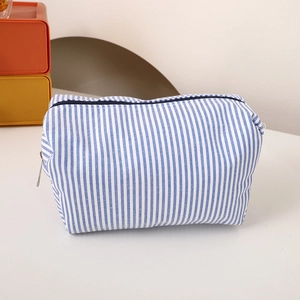 Close-up of blue and white striped canvas pencil case with top zipper closure