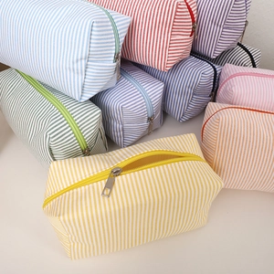 Minimalist canvas pencil case with a colorful striped design and metal zipper closure