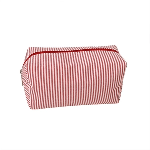 Minimalist red and white striped canvas pencil case with zipper closure on white background