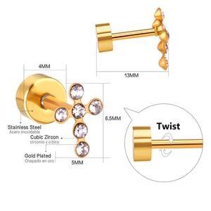 Macro view of gold cross earring showing screw back details and cubic zirconia inlay