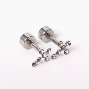 Close-up of silver cross stud earrings with sparkling crystals and screw back design