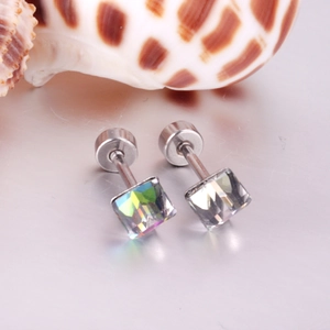 Macro detail of square iridescent crystal earrings with screw backs on a shell background