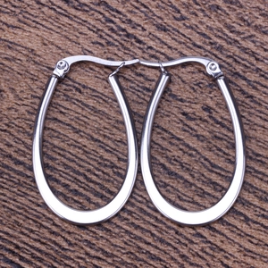 Detailed view of polished silver U-shaped hoop earrings with a classic snap closure