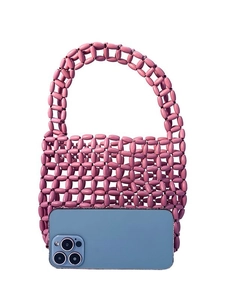 Pink beaded handmade tote bag with hollow-out design shown next to a smartphone