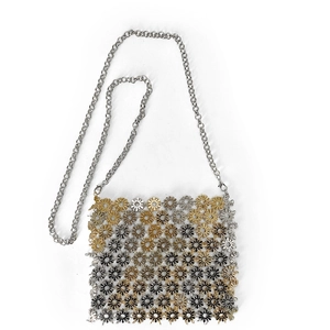 Detailed view of hollow floral metal pieces and slim silver chain on a crossbody phone bag