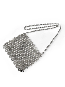 Detail view of silver metal floral hollow-out shoulder bag with sleek chain strap