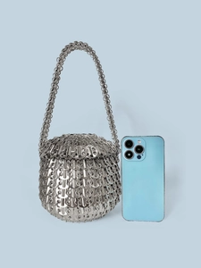 Detailed close-up of a silver handmade sequin tote bag with a phone for size reference
