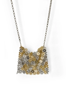Detailed macro view of mixed gold and silver metal floral links on a mini chain handbag
