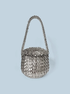 Macro shot of handcrafted interlocking silver metal scales and woven industrial mesh texture