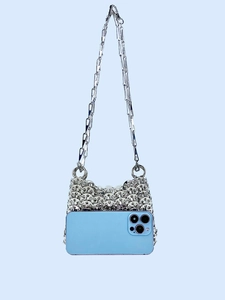 Silver sequin handmade chain shoulder bag shown with a phone to display mini capacity