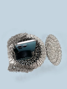 Macro detail of silver sequin bag showing mesh structure and interior storage capacity