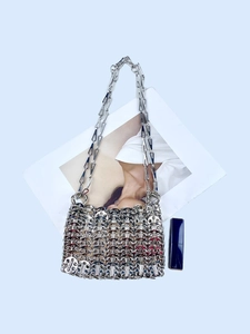 Detail of silver sequin chain bag showing metallic mesh texture and silver chain strap