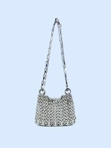 Close-up of metallic silver chainmail fabric and matching chain shoulder strap