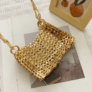 Detail of handmade gold metal chainmail handbag with interlocking shimmering sequins