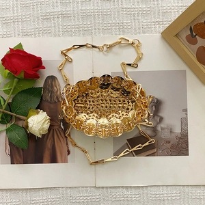 Detail of handmade gold sequin chain bag showing woven metallic discs and texture