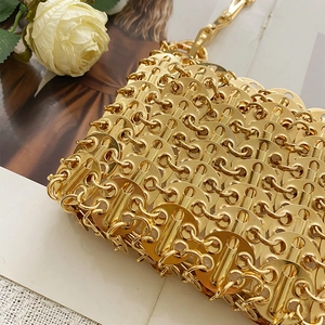 Close-up of handmade gold metal sequin bag featuring intricate woven chain craftsmanship