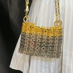 Detail of handmade gold and silver sequin chain bag with metallic ring weave texture