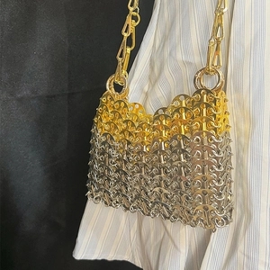 Detail of handmade metallic chainmail weave showing gold and silver sequin textures
