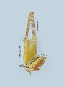 Amber beaded handbag with tassel fringe and gold silk lining on light blue backdrop
