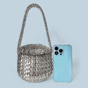 Handmade silver metal sequin handbag with chain strap shown with mobile phone for size