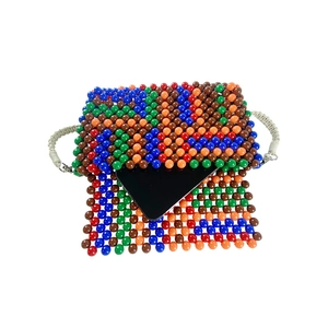 Detail showing the internal capacity of the colorful beaded bag with a smartphone