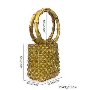 Detail view of amber beaded handbag with bamboo handle showing dimensions 13x12x5cm