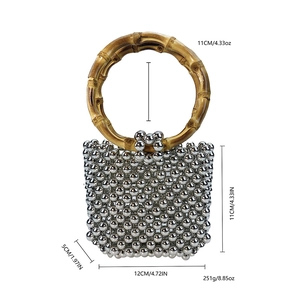 Silver beaded handbag with bamboo style handles and product dimensions for reference