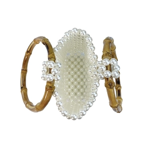 Top view of handmade white pearl beaded handbag with natural bamboo circular handles