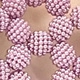 Macro detail of hand-woven pink pearl bead sphere for kids mini crossbody handbag